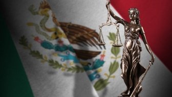 Mexico flag with statue of lady justice and judicial scales in dark room. Concept of judgement and punishment, background for jury topics