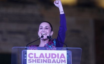 Claudia Sheinbaum with arm raised