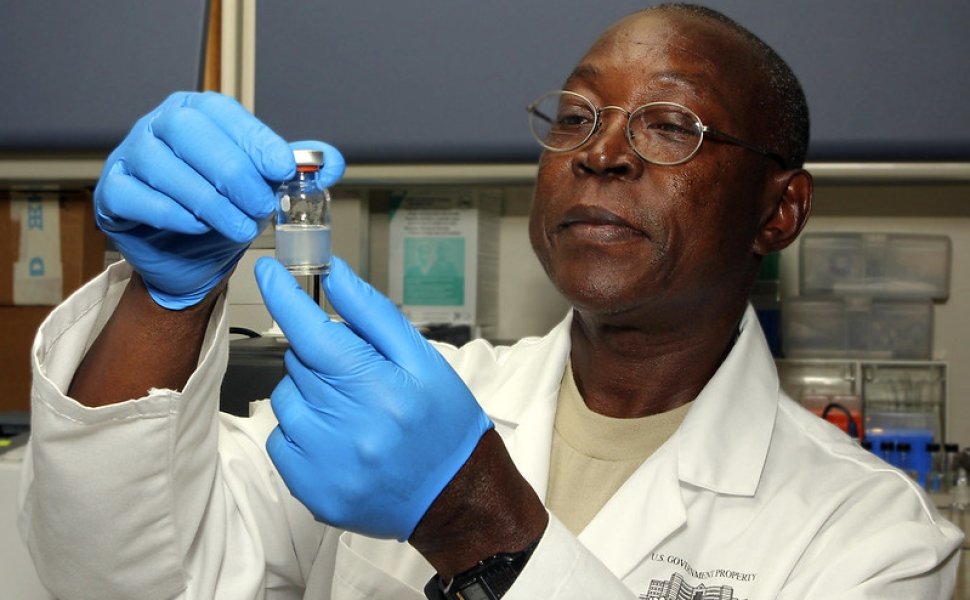 Biochemist looking at vial